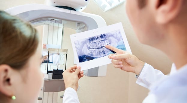 Dentist showing a patient their dental x-rays at Perspective Dental